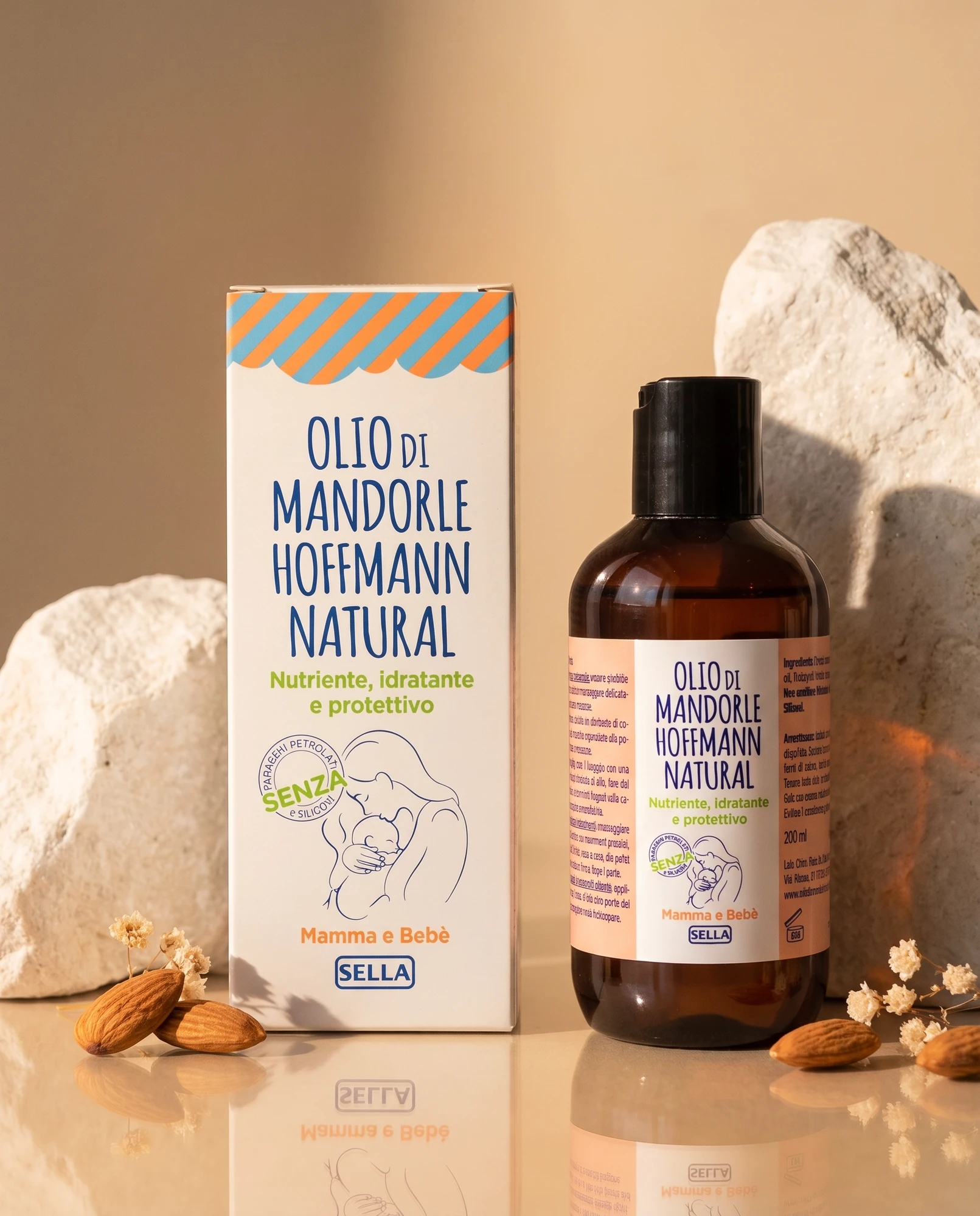Confezione e flacone di Olio di Mandorle Hoffmann Natural tra rocce bianche e mandorle su fondo caldo